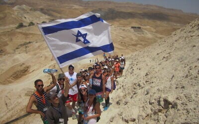 Young Jewish adults hike up Masada near the Dead Sea during their 10-day Birthright trip. (courtesy)