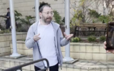 Far-left journalist Israel Frey speaks to supporters outside a police station in Tel Aviv, March 12, 2025. (Screen capture: X/Oren Ziv, used in accordance with Clause 27a of the Copyright Law)