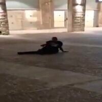 Ahmad Nijam lies on the ground after being shot in downtown Jerusalem on March 12, 2025. (Screen capture/X)