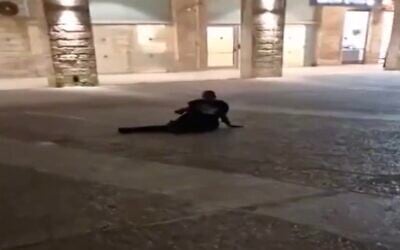Ahmad Nijam lies on the ground after being shot in downtown Jerusalem on March 12, 2025. (Screen capture/X)