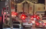 Police cars at the scene of a shooting in the northern Arab village of Deir Hanna, March 14, 2025. (Screen capture: Ynet, used in accordance with Clause 27a of the Copyright Law)
