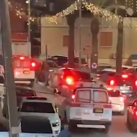 Police cars at the scene of a shooting in the northern Arab village of Deir Hanna, March 14, 2025. (Screen capture: Ynet, used in accordance with Clause 27a of the Copyright Law)