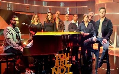 Singer and performer Hanan Ben Ari, left, with the cast of 'Eretz Nehederet' singing a song for hostage Alon Ohel, March 2025 (Courtesy)