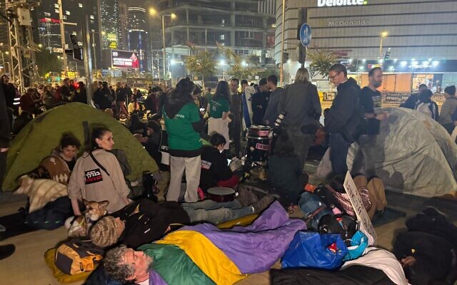 Protesters settle in for the night at the Begin Gate of the IDF's Kirya headquarters in Tel Aviv, March 8, 2025, vowing not to leave until all hostages are released from Gaza. (Naama Zeevi / Pro-Democracy Protest Movement)