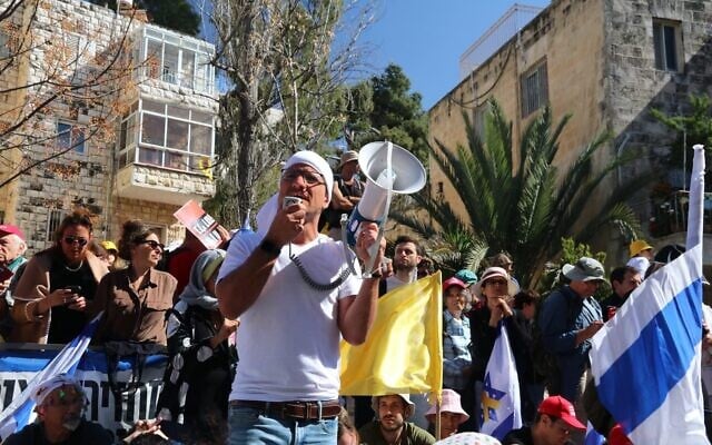 Anti-government protest leader Moshe Radman speaks at a protest outside Prime Minister Benjamin Netanyahu's residence on Azza Road in Jerusalem against his decision to fire Shin Bet head Ronen Bar, March 19, 2025. (Amir Yaacobi/Pro-Democracy Protest Movement)