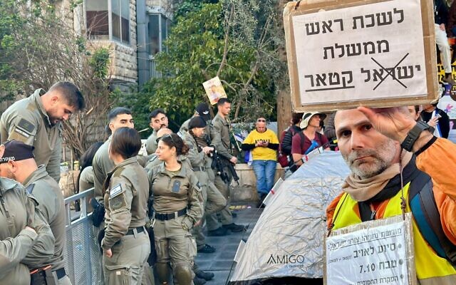 A protester on Jerusalem’s Azza Street holds a sign reading, ‘The Office of the Prime Minister of Qatar,' during a protest in Jerusalem on March 23, 2025. (Sagiv Shifman/ Pro-Democracy Protest Movement) A protester on Jerusalem’s Azza Street holds a sign reading, ‘The Office of the Prime Minister of Qatar,' during a protest in Jerusalem on March 23, 2025. (Sagiv Shifman/ Pro-Democracy Protest Movement)