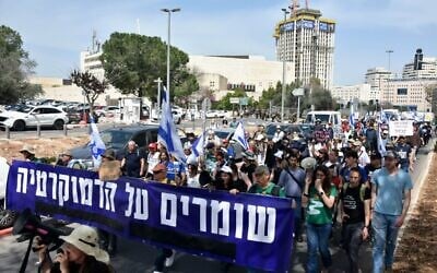 Protesters march toward the Knesset on March 25, 2025, holding a banner that reads, 'Protecting Democracy' (Credit Yair Palti/Pro-Democracy Protest Movement)