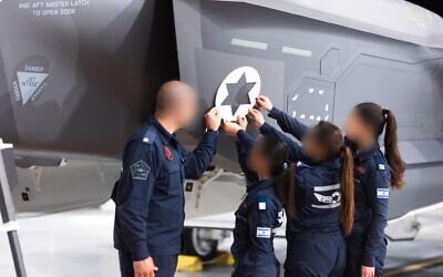 IAF decals are placed on newly arrived F-35 fighter jets in a photo released March 16, 2025 (Israel Defense Force)
