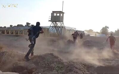 Hamas terrorists attack the IDF's Nahal Oz base on October 7, 2023, as seen in footage released by the terror group. (Screenshot: Telegram)