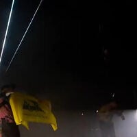 A member of Irish band Kneecap waves a Hezbollah flag at a concert in London on November 21, 2024 (Screen grab/YouTube)