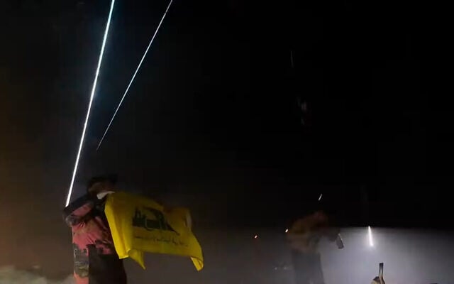 A member of Irish band Kneecap waves a Hezbollah flag at a concert in London on November 21, 2024 (Screen grab/YouTube)