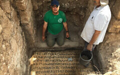 Prof. Jacob Ashkenazi from the Kinneret College on the Sea of Galilee as he cleans an inscription found in Horvat Hesheq, between Carmiel and Maalot, in 2018. (Prof. Jacob Ashkenazi)