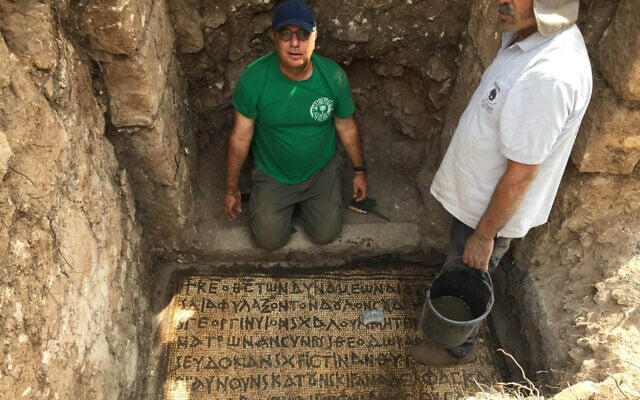 Prof. Jacob Ashkenazi from the Kinneret College on the Sea of Galilee as he cleans an inscription found in Horvat Hesheq, between Carmiel and Maalot, in 2018. (Prof. Jacob Ashkenazi)