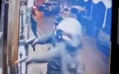 Security camera footage from the scene of a triple homicide shows two masked gunmen opening fire at a hookah store in the central city of Ramle, April 11, 2025. (X screenshot; used in accordance with Clause 27a of the Copyright Law)