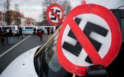 Illustrative: A prohibition sign with a swastika is seen on the bonnet of a car during a demonstration near the fairground in Dresden, Germany on April 10, 2021. (Jens Schlueter/AFP)