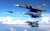 Handout picture released by Colombian Air Force showing Kfir combat airplane from the Colombian Air Force and a F15 jet (L) of the US Air Force during a military exercise in Puerto Salgar, Colombia, on September 8, 2023. (Handout / Colombian Air Force / AFP)