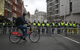 Police officers guard a barrier close to the Israeli embassy, the destination for a National March for Palestine in central London on February 17, 2024. (JUSTIN TALLIS / AFP)