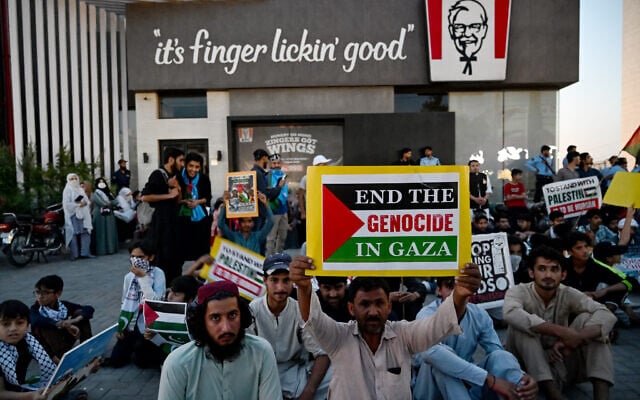 Supporters of Islami Jamiat-e-Talaba (IJT), a student wing of Pakistan's Jamaat-e-Islami (JI) party stage a pro-Palestinian protest outside a Kentucky Fried Chicken restaurant calling for boycott of Israeli products on the outskirts of Islamabad, Pakistan, on May 7, 2024. (Farooq NAEEM / AFP)
