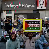 Supporters of Islami Jamiat-e-Talaba (IJT), a student wing of Pakistan's Jamaat-e-Islami (JI) party stage a pro-Palestinian and anti-Israel protest outside a Kentucky Fried Chicken (KFC) restaurant calling for boycott of Israeli products on the outskirts of Islamabad on May 7, 2024. (Farooq Naeem/AFP)
