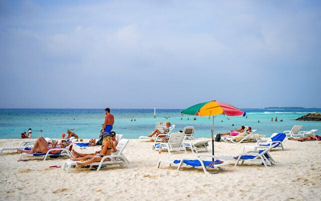 Tourists relax at a beach in Maafushi, an island in Maldives, on October 22, 2024. (Mohamed Afrah / AFP) Tourists relax at a beach in Maafushi, an island in Maldives, on October 22, 2024. (Mohamed Afrah / AFP)