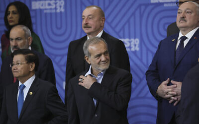 Laotian President Thongloun Sisoulith (L), Azerbaijani President Ilham Aliyev (2nd-L), Iranian President Masoud Pezeshkian (C) and Belarus President Alexandr Lukashenko (R) and participants in the outreach/BRICS Plus format meeting pose for a family photo during the BRICS summit in Kazan, Russian, on October 24, 2024. (MAXIM SHIPENKOV / POOL / AFP)
