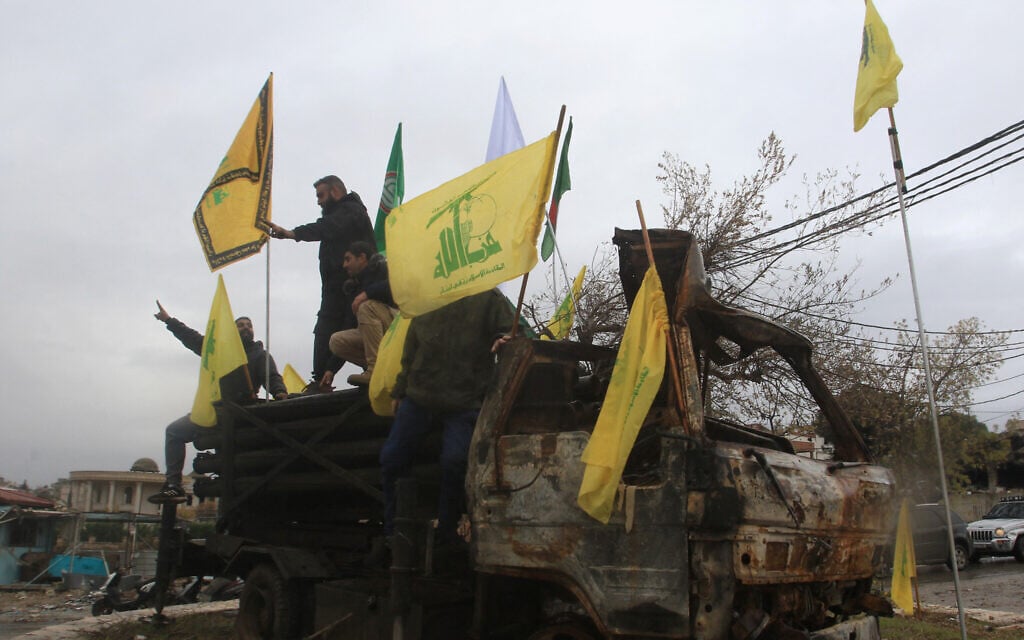 People pose for a picture on a burnt Hezbollah rocket launcher in the southern Lebanese village of Kfar Tibnit on November 27, 2024, after a ceasefire between Israel and Hezbollah took effect. (Mahmoud Zayat/AFP) People pose for a picture on a burnt Hezbollah rocket launcher in the southern Lebanese village of Kfar Tibnit on November 27, 2024, after a ceasefire between Israel and Hezbollah took effect. (Mahmoud Zayat/AFP)