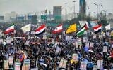 Right to left: Houthi, Yemeni, Palestinian, Hezbollah, Iraq, Iraqi Hashed Shaabi paramilitary forces and the Islamic Repubilc of Iran flags are raised at a rally denouncing Israel and in solidarity with Palestinians, in the Houthi-controlled capital Sanaa on January 3, 2025. (Mohammed Huwais/AFP)
