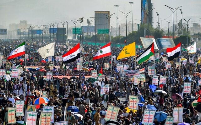 Right to left: Houthi, Yemeni, Palestinian, Hezbollah, Iraq, Iraqi Hashed Shaabi paramilitary forces and the Islamic Repubilc of Iran flags are raised at a rally denouncing Israel and in solidarity with Palestinians, in the Houthi-controlled capital Sanaa on January 3, 2025. (Mohammed Huwais/AFP) Right to left: Houthi, Yemeni, Palestinian, Hezbollah, Iraq, Iraqi Hashed Shaabi paramilitary forces and the Islamic Repubilc of Iran flags are raised at a rally denouncing Israel and in solidarity with Palestinians, in the Houthi-controlled capital Sanaa on January 3, 2025. (Mohammed Huwais/AFP)