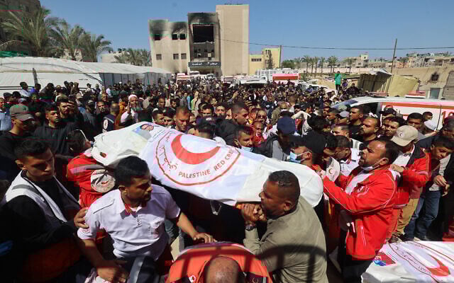 Members of the Palestine Red Crescent and other emergency services carry bodies of fellow rescuers killed a week earlier by Israeli forces, during a funeral procession at the Nasser Medical Complex in the southern Gaza Strip's Khan Younis, March 31, 2025. (Eyad Baba / AFP) Members of the Palestine Red Crescent and other emergency services carry bodies of fellow rescuers killed a week earlier by Israeli forces, during a funeral procession at the Nasser Medical Complex in the southern Gaza Strip's Khan Younis, March 31, 2025. (Eyad Baba / AFP)