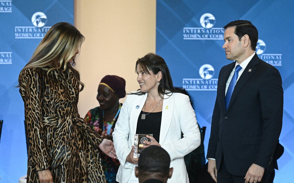 Amit Soussana (C), attorney and Israeli hostage survivor of the October 7, 2023, attack by Hamas, is honored by US Secretary of State Marco Rubio (R) and First Lady Melania Trump (L) during the International Women of Courage Awards Ceremony at the State Department in Washington, DC, on April 1, 2025. (Brendan SMIALOWSKI / AFP)