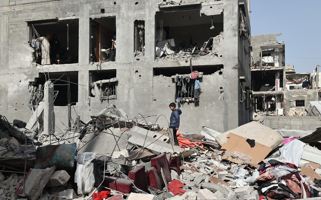 A Palestinian boy walks above the rubble of a building in an area targeted during Israeli strikes in Khan Younis in the southern Gaza Strip, on April 2, 2025 (Eyad BABA / AFP)