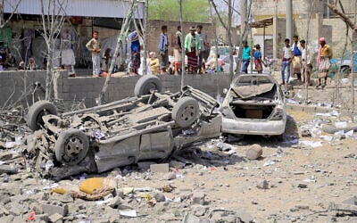 People assess the damage following reported overnight US strikes that Houthi rebels said hit the Water Management building in Mansouriya in Yemen's Hodeida governorate, on April 2, 2025. (AFP)