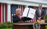 Illustrative: US President Donald Trump holds a signed executive order after delivering remarks on reciprocal tariffs during an event in the Rose Garden entitled 'Make America Wealthy Again' at the White House in Washington, DC, April 2, 2025. (SAUL LOEB / AFP)