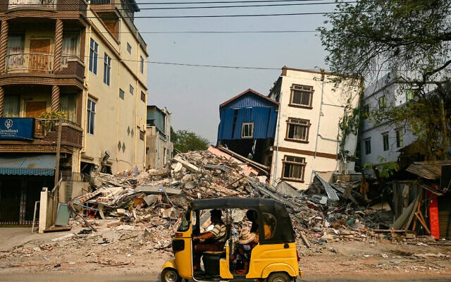 A three-wheeled motorcycle drives past collapsed and damaged buildings in Mandalay, after the March 28 earthquake struck central Myanmar, April 3, 2025. (AFP/ Sai Aung MAIN) A three-wheeled motorcycle drives past collapsed and damaged buildings in Mandalay, after the March 28 earthquake struck central Myanmar, April 3, 2025. (AFP/ Sai Aung MAIN)