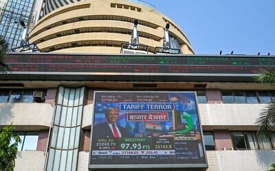 A broadcast screen of the Bombay Stock Exchange (BSE) in Mumbai, India, on April 3, 2025, depicts news of US President Donald Trump unveiling sweeping new trade tariffs. (Punit PARANJPE / AFP)