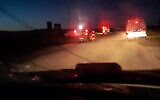 This image grab from a handout video reportedly recovered from the cellphone of an aid worker killed in Gaza alongside other rescuers and released by the Palestine Red Crescent Society on April 5, 2025, shows ambulances with their emergency lights flashing and a rescuer near one of the vehicles in Rafah in the southern Gaza Strip, according to the PRCS. (Palestinian Red Crescent/AFP)