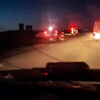 This image grab from a handout video reportedly recovered from the cellphone of an aid worker killed in Gaza alongside other rescuers and released by the Palestine Red Crescent Society on April 5, 2025, shows ambulances with their emergency lights flashing and a rescuer near one of the vehicles in Rafah in the southern Gaza Strip, according to the PRCS. (Palestinian Red Crescent/AFP)