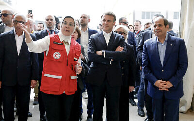 French President Emmanuel Macron (CR), Egyptian President Abdel-Fattah el-Sissi (R) and France's Minister for Europe and Foreign Affairs Jean-Noel Barrot (CL) listen to Dr Amal Emam, CEO of the Egyptian Red Crescent (2nd L), as they visit Egyptian Red Crescent warehouses storing aid for Gaza, in the Egyptian border town of El-Arish, Egypt, on April 8, 2025. (Benoit Tessier / POOL / AFP)