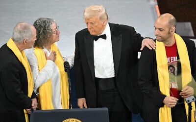 US President Donald Trump greets Israeli hostages who were released from Gaza, during the National Republican Congressional Committee's (NRCC) "President's Dinner" at the National Building Museum in Washington, DC, on April 8, 2025. (SAUL LOEB / AFP)