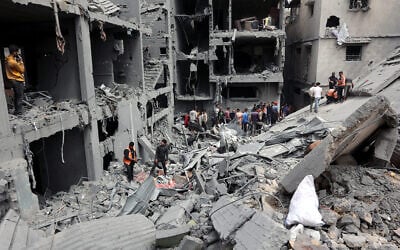 People survey the rubble after an airstrike on Gaza City's Shejaiya neighborhood, April 9, 2025. (Omar Al-Qattaa / AFP)