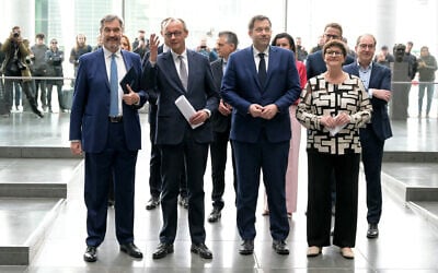 (First row, L-R) Bavaria's State Premier and leader of the conservative Christian Social Union (CSU) party Markus Soeder, Friedrich Merz, leader of Germany's conservative Christian Democratic Union (CDU) party, and the co-leaders of Germany's social democratic SPD party Lars Klingbeil and Saskia Esken arrive to address journalists after they found an agreement to form a new government, on April 9, 2025 in Berlin. (Tobias SCHWARZ / AFP)