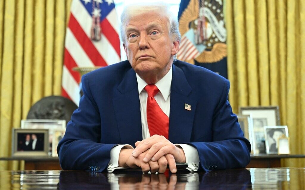 US President Donald Trump looks on after signing an executive order in the Oval Office of the White House on April 9, 2025, in Washington, DC. (Photo by SAUL LOEB / AFP)