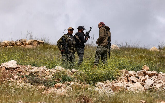 Israeli soldiers watch from a hill after army bulldozers demolished houses belonging to the Al-Hirsh family, in the village of Al-Rihaya, south the West Bank city of Hebron on April 10, 2025. (HAZEM BADER / AFP) Israeli soldiers watch from a hill after army bulldozers demolished houses belonging to the Al-Hirsh family, in the village of Al-Rihaya, south the West Bank city of Hebron on April 10, 2025. (HAZEM BADER / AFP)