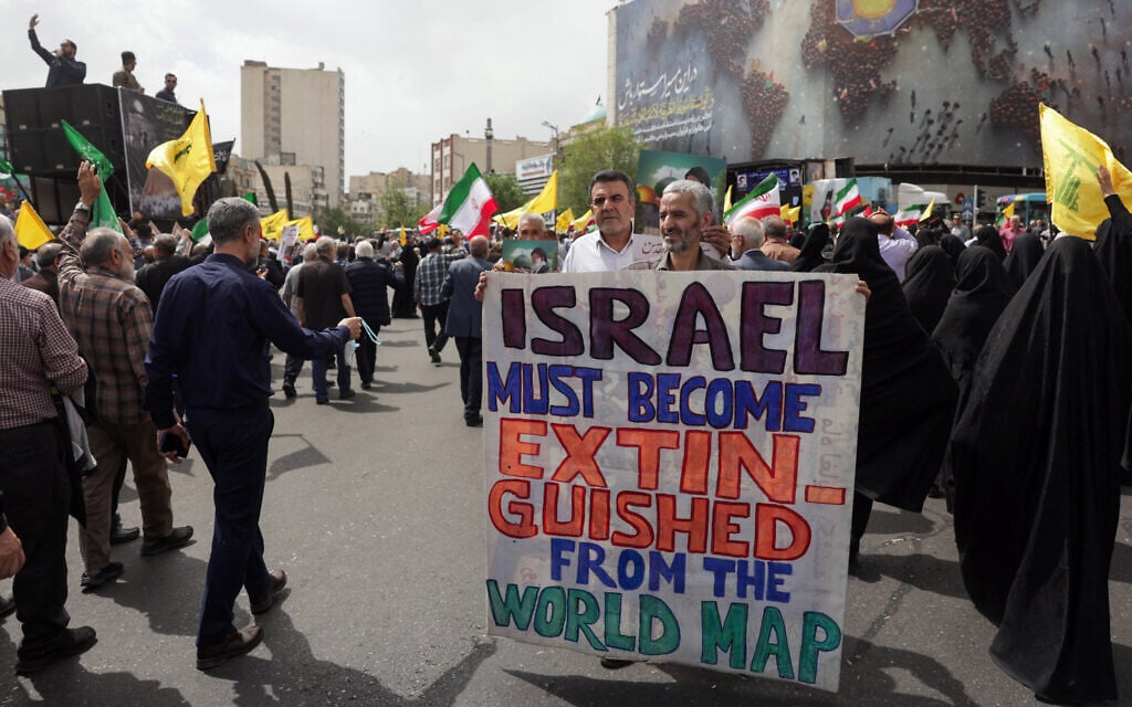 Iranians lift flags and placards during a rally in Tehran on April 11, 2025, in support of Palestinains and to denounce Israel's resumption the previous month of its air strikes on Gaza. (AFP)