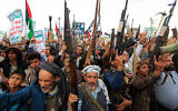 Demonstrators shout slogans and raise their assault rifles during a rally in solidarity with Palestinians in the Gaza Strip and in condemnation of US strikes, outside Sanaa's Saleh Grand Mosque in Yemen's Houthi-controlled capital on April 11, 2025. (Mohammed HUWAIS / AFP)