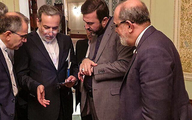 This handout picture provided by Khabar Online on April 12, 2025, shows Iran's Foreign Minister Abbas Araghchi (2nd-L) speaking with members of the Iranian delegation after a meeting in Muscat during nuclear talks with the US. (Photo by KhabarOnline / AFP) This handout picture provided by Khabar Online on April 12, 2025, shows Iran's Foreign Minister Abbas Araghchi (2nd-L) speaking with members of the Iranian delegation after a meeting in Muscat during nuclear talks with the US. (Photo by KhabarOnline / AFP)