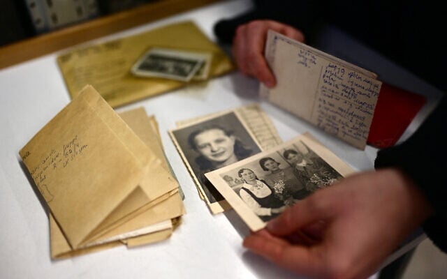 An employee shows photos, former belongings of victims and survivors of Nazi regime, in a storage house at the Arolsen Archives in Bad Arolsen, Germany on March 6, 2025. (Ina Fassbender/AFP)
