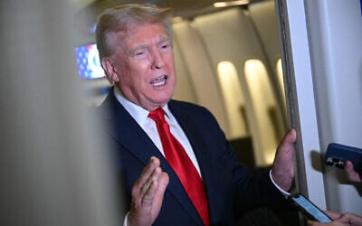 US President Donald Trump speaks to reporters aboard Air Force One, during the flight from Palm Beach to Joint Base Andrews, as he returns to the White House in Washington, DC, April 13, 2025. (Mandel NGAN / AFP)