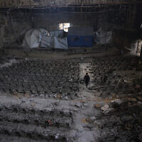 A boy inspects the auditorium in the heavily damaged Islamic University campus where Palestinian families took refuge, in Gaza City on April 16, 2025. (Photo by BASHAR TALEB / AFP)