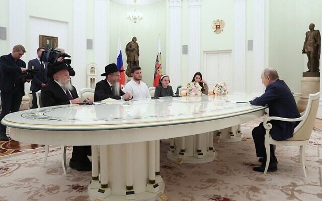 In this pool photograph distributed by the Russian state agency Sputnik, Russia's President Vladimir Putin meets with freed Palestinian Islamic Jihad and Hamas hostages Sasha Troufanov, Yelena Trufanova and Sapir Cohen at the Kremlin in Moscow on April 16, 2025. (Sofia Sandurskaya/Pool/AFP)